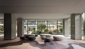A modern, contemporary lobby featuring concrete elements and a textured surface