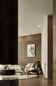A modern living room featuring a wooden sofa, chair, and coffee table under natural light.