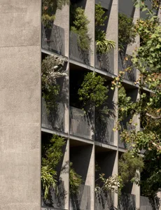Concrete building with greenery on balconies