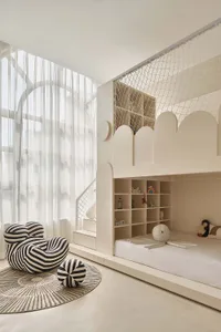 Minimalist bedroom with white furniture and a netted sleeping area