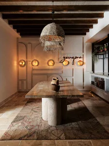 A stylish concrete entryway with a rustic pendant light and ambient lighting