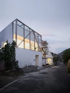 Modern house with glass walls and concrete exterior in white color
