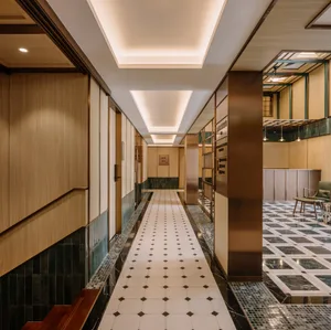A modern interior hallway with wooden walls and ceramic tile flooring.