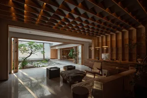 Modern living room featuring wooden furniture and a stone coffee table.