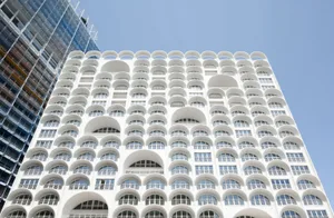Modern building featuring a glass facade with white arches.