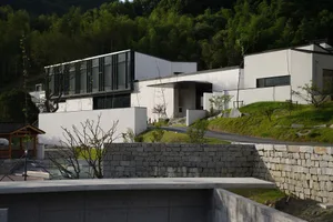 A modern house featuring concrete and glass exterior.