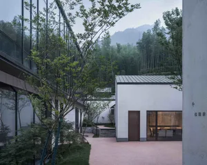 Modern residential space with glass walls and concrete finishes