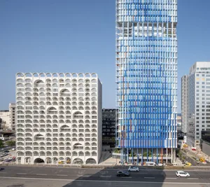 A modern high-rise building constructed with glass and steel materials.