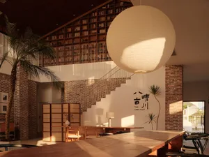 A cozy living room with wooden furnishings, stairs, and a large spherical light fixture.