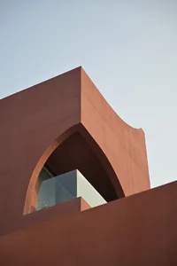 A modern building exterior with a concrete facade and geometric shapes.