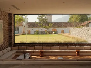 Interior design featuring modern furniture with a brick concrete wall