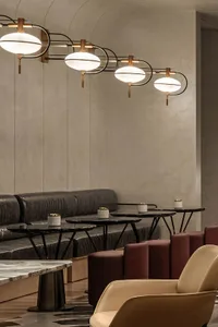 Modern lounge area featuring concrete seating and tables with potted plants.
