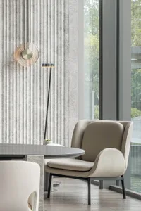 A modern, minimalist living room featuring concrete furniture and a sleek, contemporary design.