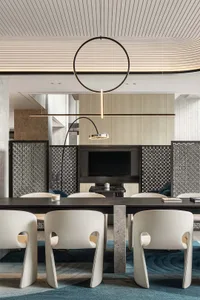Modern office dining room with metal yarn ceiling, brick accent wall, and stone elements