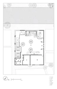 2D floor plan of a building with labeled rooms and a compass direction.