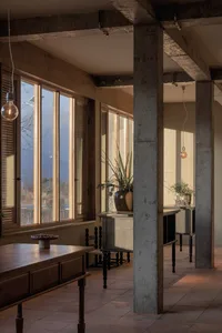 Industrial-style room with concrete, wooden, and glass elements