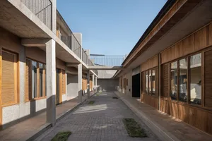 A modern architectural design featuring concrete and wooden elements.