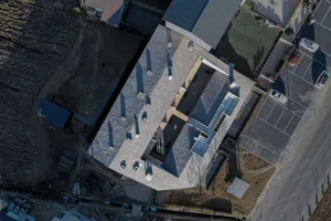 Aerial view of a modern building with a stone exterior.