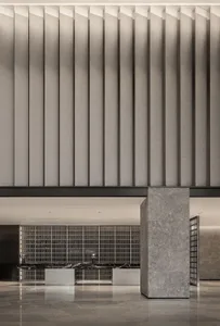 A modern lobby interior with concrete walls and a minimalist design.