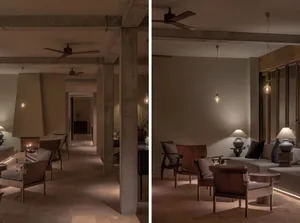 Modern lounge area with concrete and wood materials, featuring a cozy seating area and warm lighting.