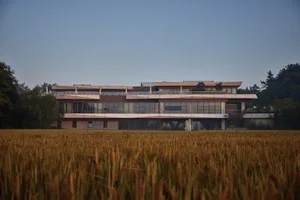 Modern residential building surrounded by agricultural field