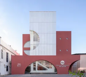Modern residential building with glass and concrete facade.