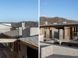 Modern residential building constructed with granite walls and wooden elements.