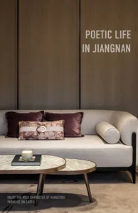 A modern living room with a fabric couch, wooden paneling, and marble accents.