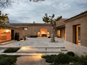 A modern residential exterior featuring concrete tiles with a warm, inviting atmosphere.