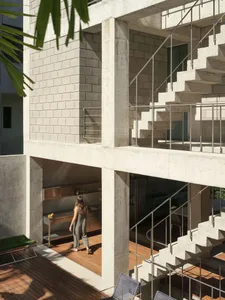 Modern architecture featuring a concrete exterior with stainless steel and wooden elements.