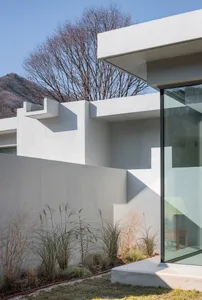 Modern exterior house with concrete walls and glass windows.