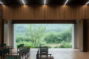 Modern lighting design featuring glass panels and wooden furnishings in an indoor spa setting.