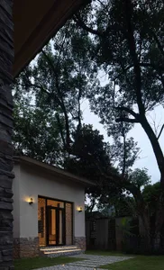 A modern residential exterior with stone and glass materials.
