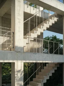 Concrete stairs with metal railings in a modern architectural setting.