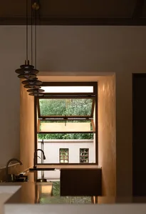 A modern residential kitchen featuring a glass window and wooden elements.