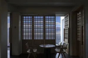 Modern residential space featuring wooden fence and view of the sea