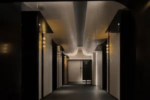 A modern corridor featuring concrete walls and illuminated pathways