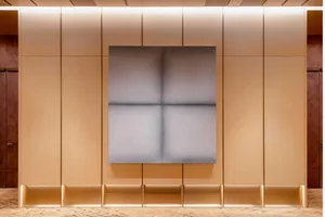 A minimalist interior design with a metallic canvas wall.
