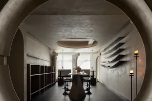 Modern dining room with metallic shelves and concrete floor