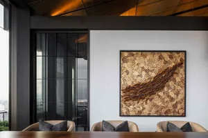 A modern dining room featuring a textured wood accent wall and black-framed sliding glass doors overlooking an outdoor terrac