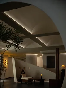 A modern entrance hall with concrete walls and lighting.