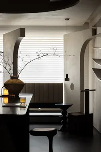 Modern interior design featuring concrete walls and minimalist furniture.