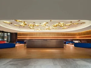 Modern lobby featuring leather couches and wooden ceilings
