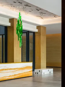 Modern office reception area featuring glass and concrete elements.