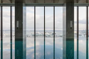Modern glass pool overlooking a cityscape