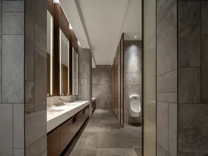 Modern toilet rooms featuring concrete tiles and walls.