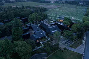 A modern residential building with black metal exterior.