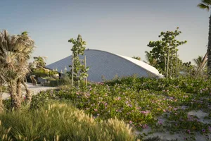 a minimalist building featuring a metal roof.