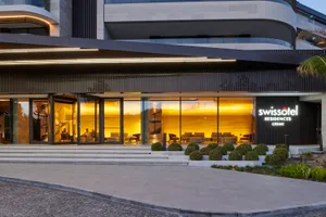 Modern hotel entrance with glass and concrete materials
