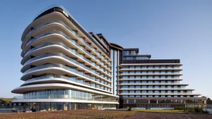 Modern hotel resort building with glass and concrete exterior.